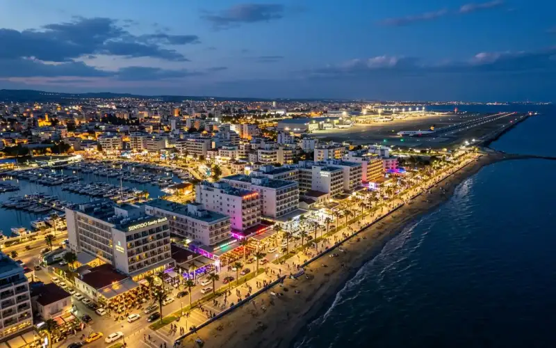 Vibrant nightlife illuminates Larnaca's skyline, a bustling Cypriot hub perfect for exploring beaches and day trips